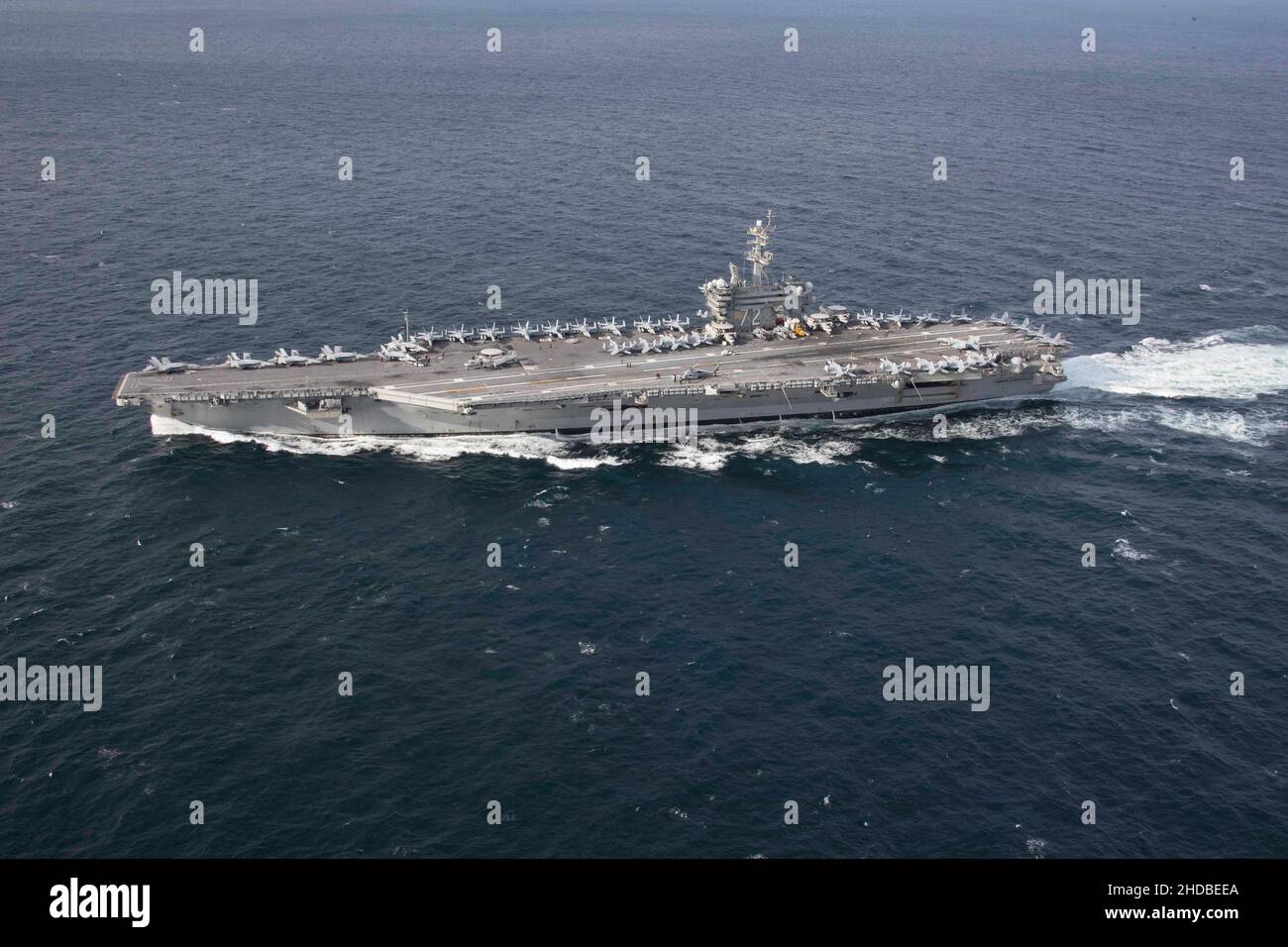 The Nimitz-class aircraft carrier USS Abraham Lincoln (CVN 72) transits the Atlantic Ocean during a strait transit exercise in the Atlantic Ocean on January 30, 2019. Abraham Lincoln is underway conducting Composite Training Unit Exercise (COMPTUEX) with Carrier Strike Group (CSG) 12. The components of CSG 12 embody a “team-of-teams” concept, combining advanced surface, air and systems assets to create and sustain operational capability. This enables them to prepare for and conduct global operations, have effective and lasting command and control, and demonstrate dedication and commitment to b Stock Photo