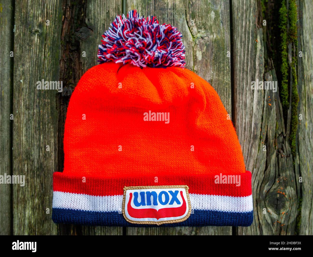 A view of Unox traditional orange beanie placed on a wood table. This week  marks exactly 25 years since the last Elfstedentocht event (a long-distance  tour skating event on natural ice, almost