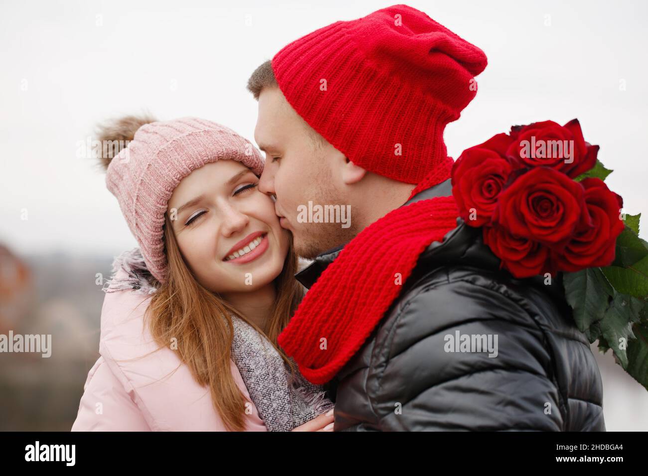 Red Roses Couple Young beautiful couple with red roses outdoors Stock Photo - Alamy