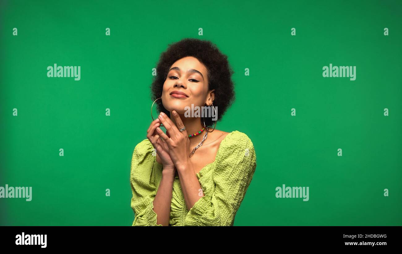 Positive african woman in green hi-res stock photography and images - Alamy
