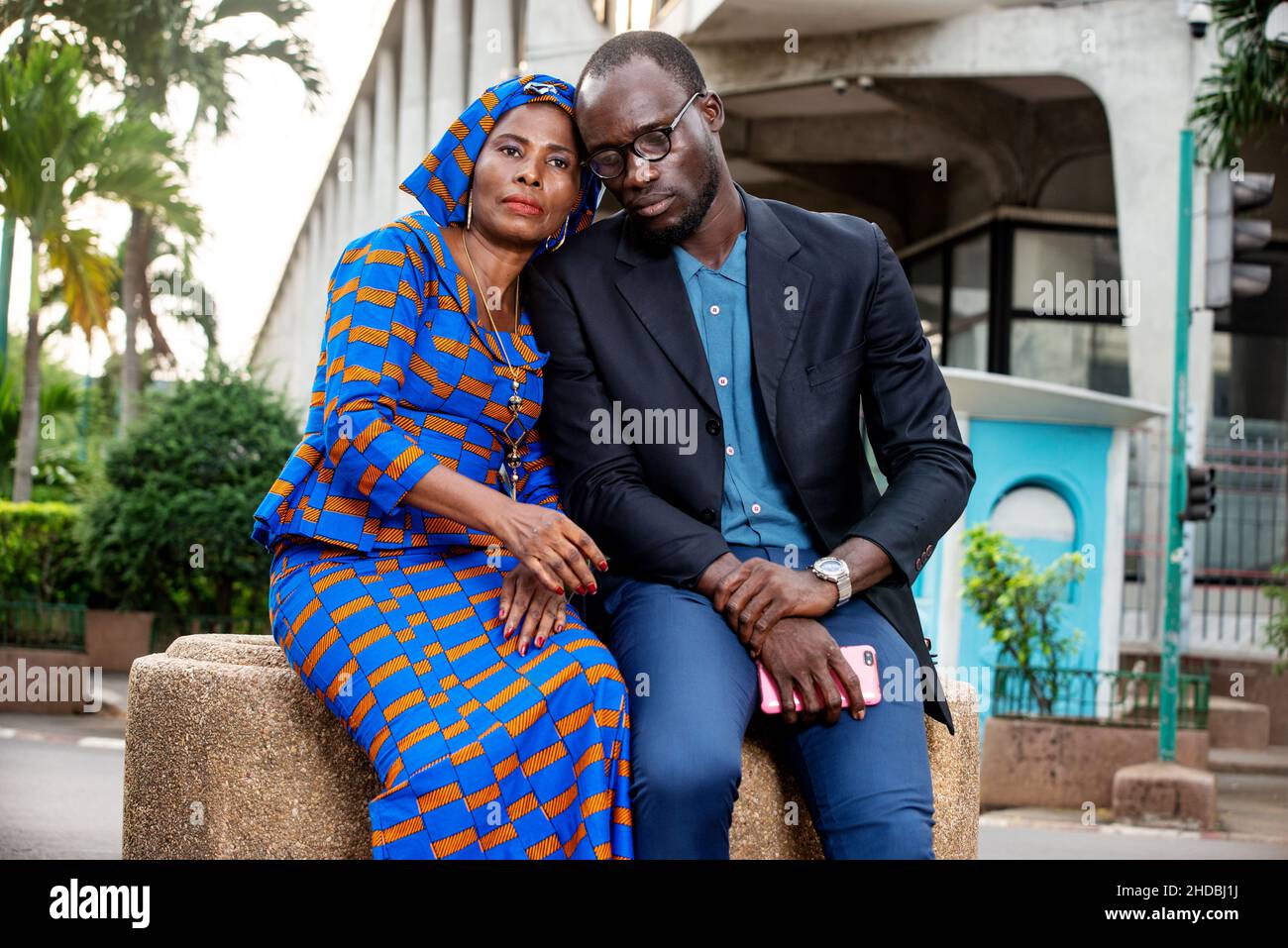 beautiful African couple sitting outdoors embracing Stock Photo - Alamy