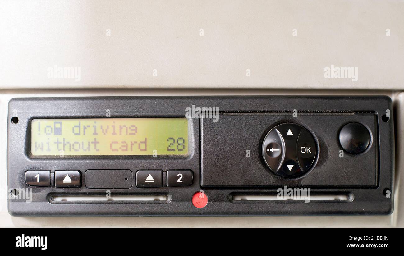 Digital tachograph display reads DRIVING WITHOUT CARD. No inserted card in the device. Insert the drivers card. No personal data. Stock Photo