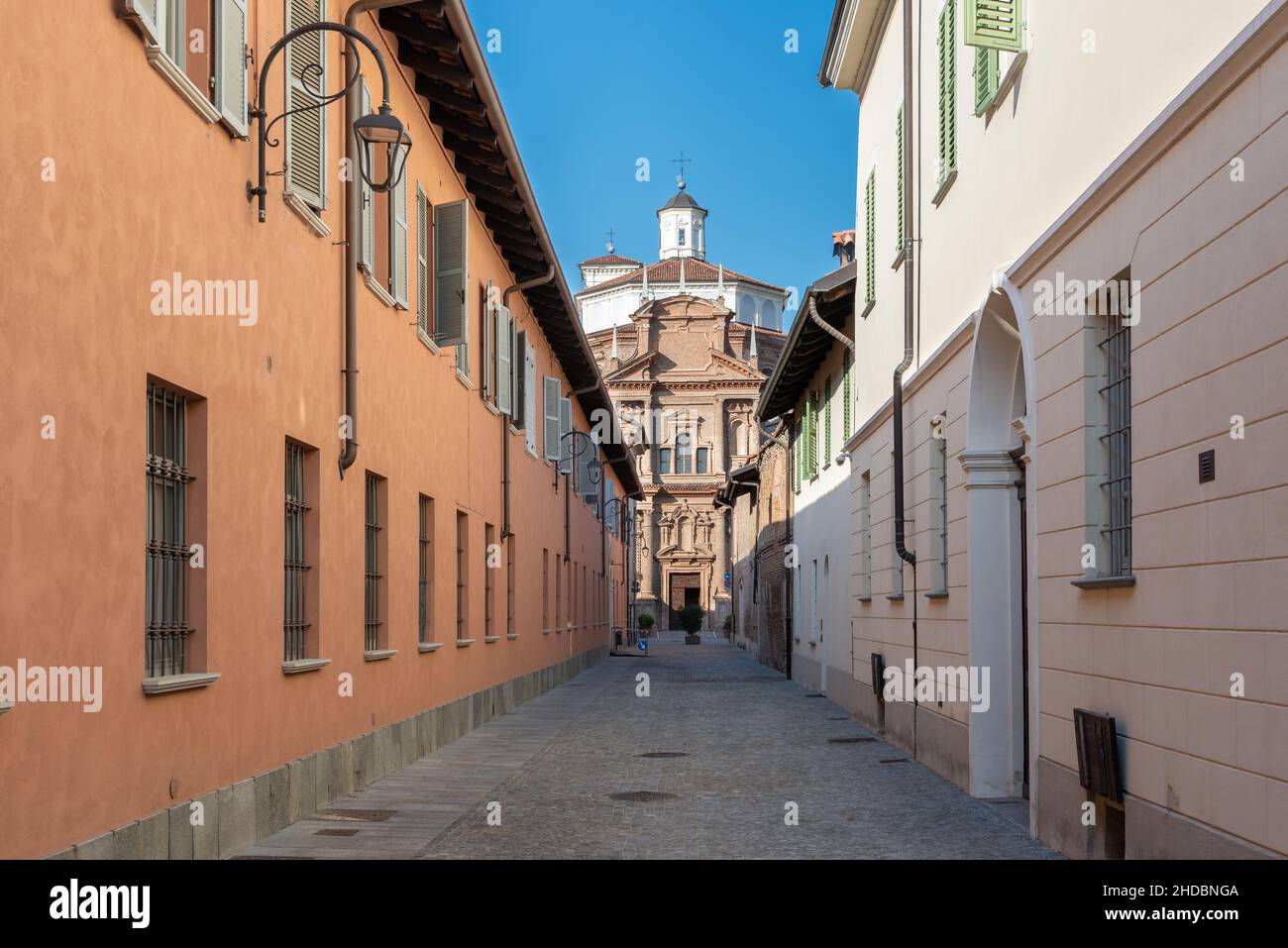 Cherasco, Cuneo, Italy - October 27, 2021: via dell'Ospedale with retirement home Ospedale degli Infermi, in the background Sanctuary of Our Lady of t Stock Photo