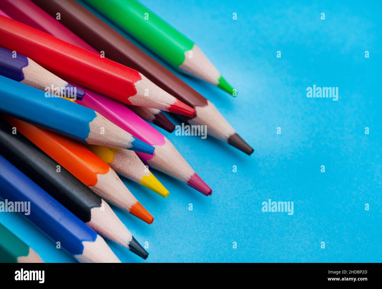 Colored pencils on bright colored background Stock Photo