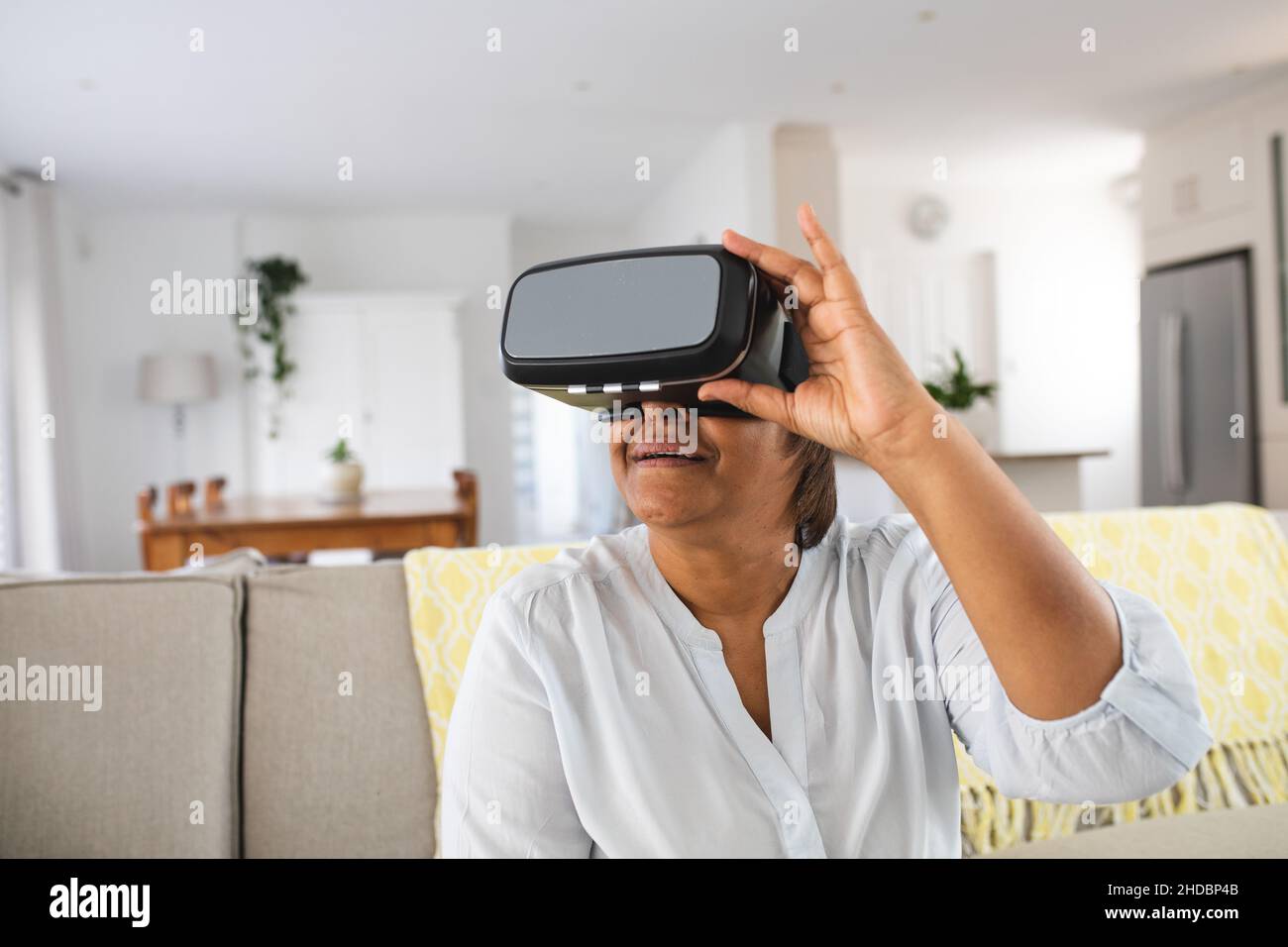 African american elderly woman using wearing virtual reality simulator ...