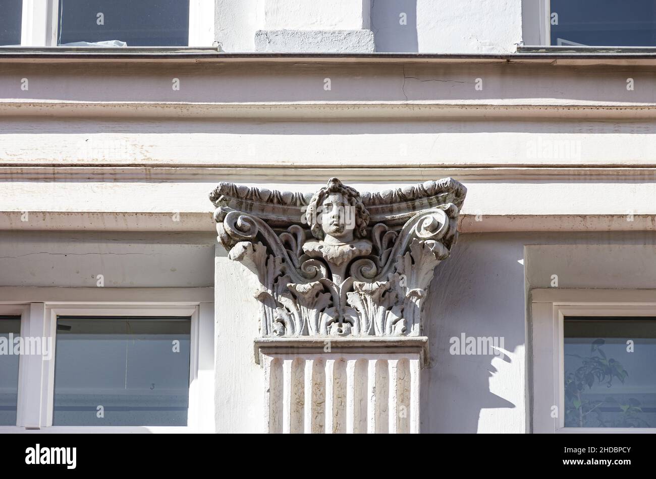 Facade detail of a face on a capital, residential and commercial building of Kröpeliner Straße No. 93, Hanseatic City of Rostock, Germany. Stock Photo