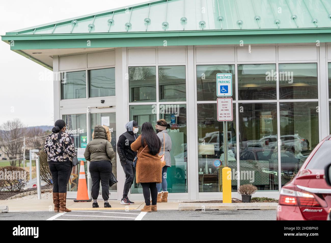 Spring Township, Pennsylvania: January 3, 2022: People waiting in line outside Patient First and Urgent Care as the waiting room was full Stock Photo