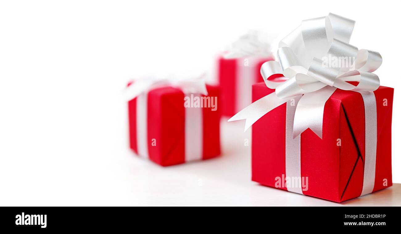 Red gift boxes with white bow on a white background Stock Photo - Alamy