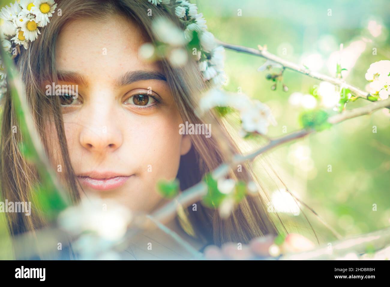 cute girl with chamomiles on hair Stock Photo - Alamy