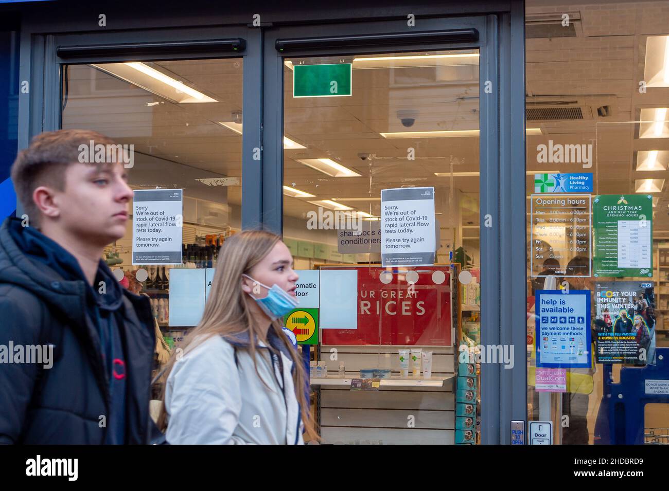 Egham, Surrey, UK. 5th January, 2022. People walk past a sign in the