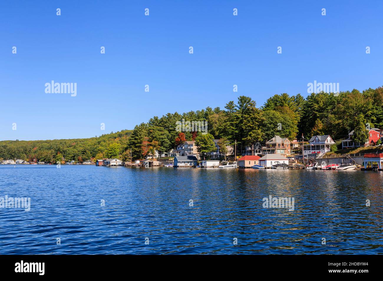 Shoreline houses, properties and moorings at Alton Bay, Lake Winnipesaukee, Alton, New Hampshire, New England, USA on a sunny day with blue sky Stock Photo