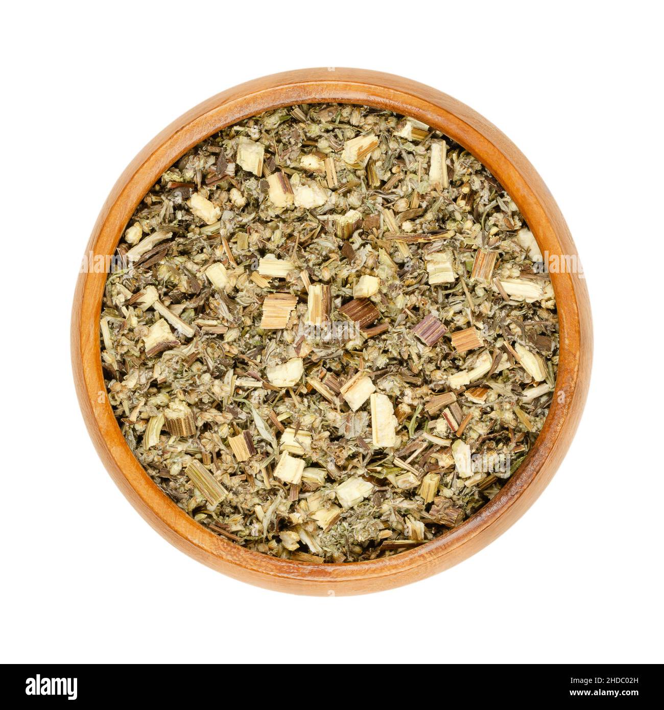 Mugwort herb in wooden bowl. Dried, cut common mugwort, Artemisia vulgaris, also riverside wormwood, felon herb, chrysanthemum weed or old Uncle Henry. Stock Photo