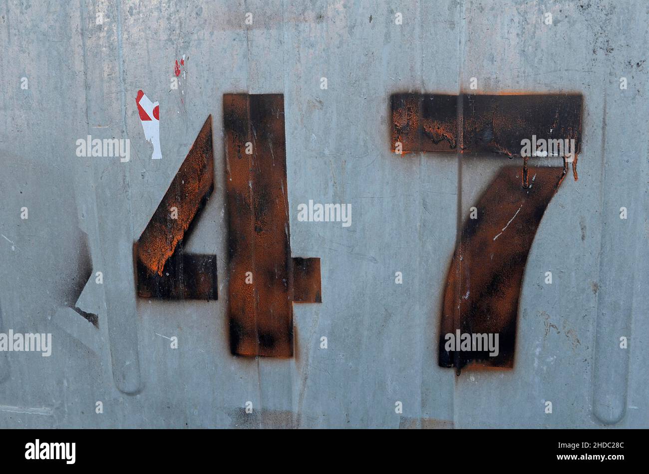 Number 47 sprayed on grey metal wall Stock Photo