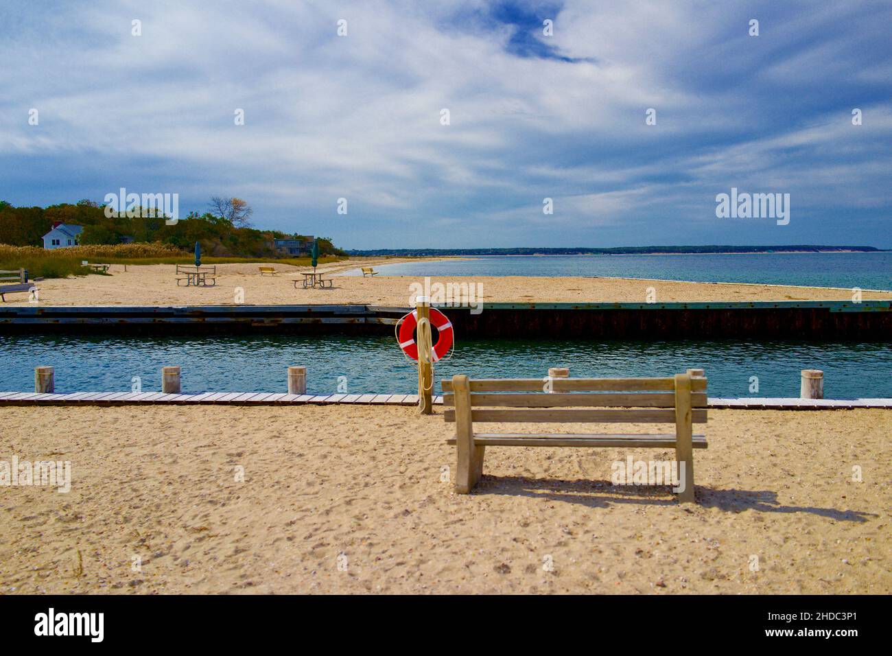 Boat channel and beach in East Hampton with benches.  Empty, no people in this bright summer day photograph. Stock Photo