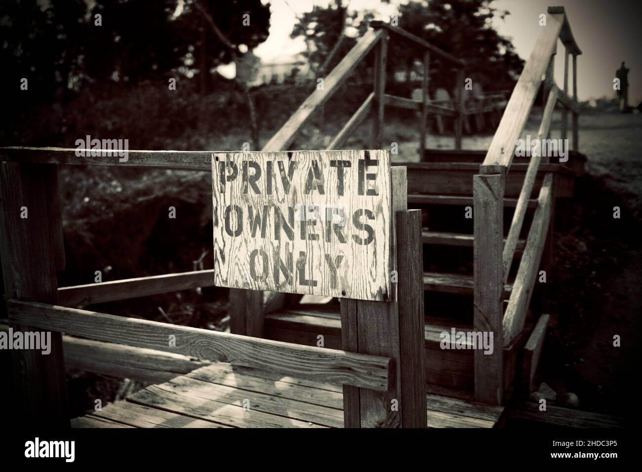 Private Owners Only hand painted sign at entrance to wooden steps and