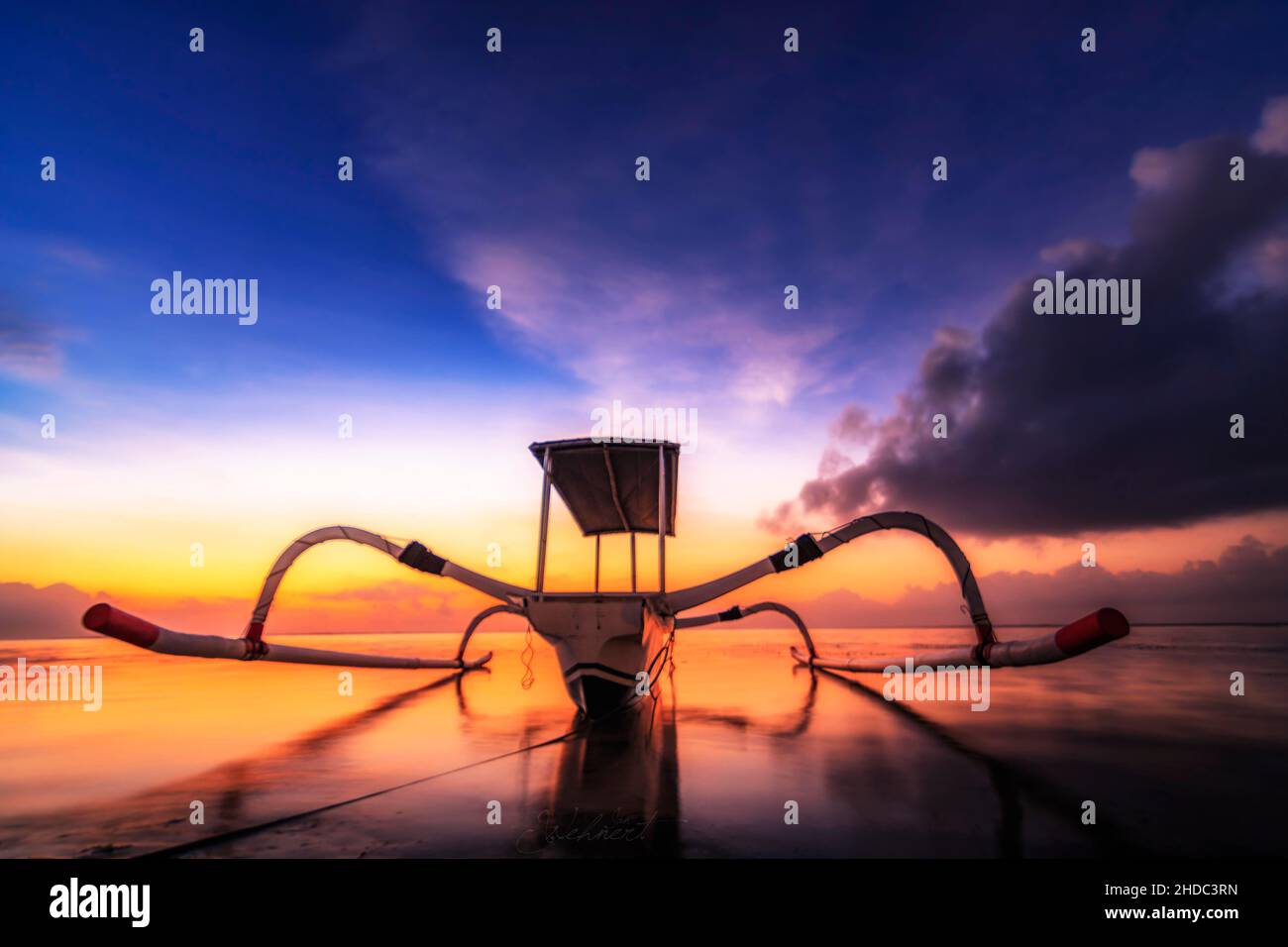 Outrigger boat, Jukung, on the beach and sunrise, Sanur Beach, Bali, Indonesia Stock Photo