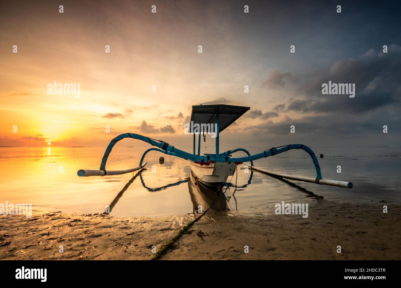 Outrigger boat, Jukung, on the beach and sunrise, Sanur Beach, Bali, Indonesia Stock Photo