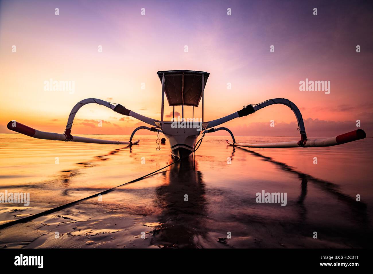 Outrigger boat, Jukung, on the beach and sunrise, Sanur Beach, Bali, Indonesia Stock Photo