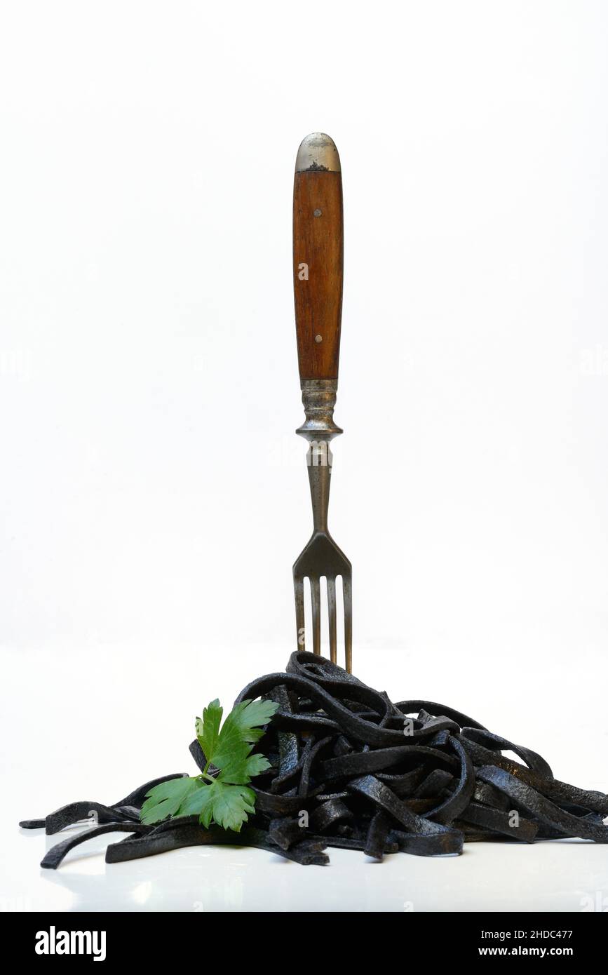 Black pasta with squid ink with fork, Tagliolini al Nero di Seppia, Italy Stock Photo