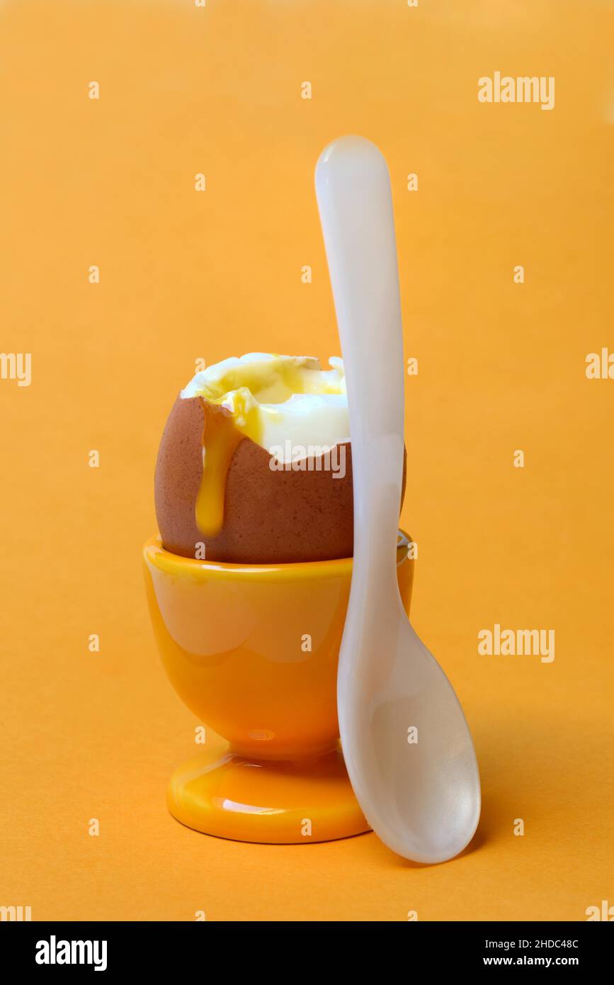 Soft boiled breakfast egg in egg cup with spoon Stock Photo