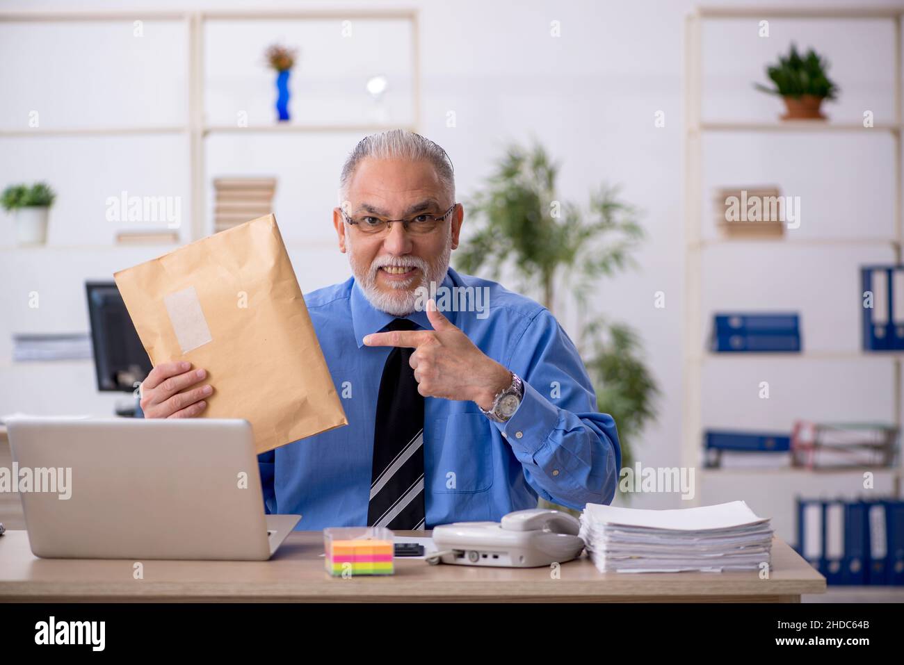 Old businessman employee receiving parcel via Internet Stock Photo - Alamy