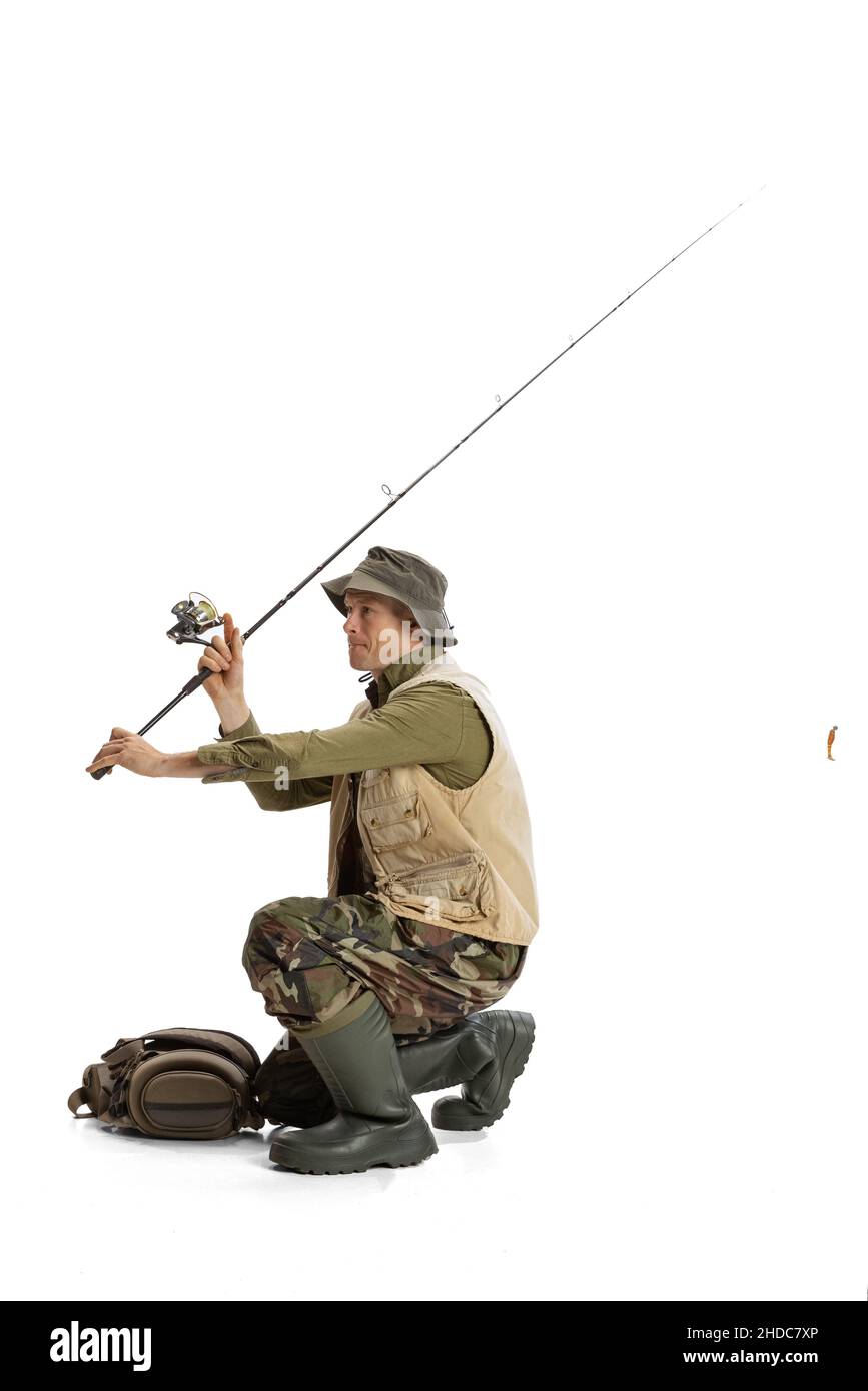 Portrait of young man, professional fishman with fishing rod, spinning and  equipment going to river isolated over white studio background Stock Photo  - Alamy