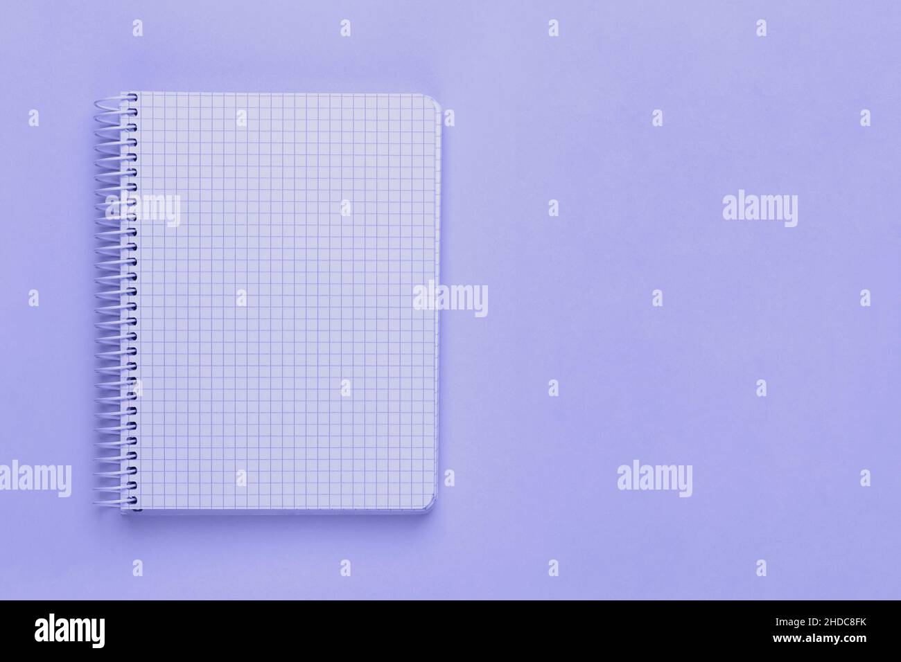 Trendy very peri color of the year 2022, violet blue, lavender open spiral notebook with blank empty sheets with copy space Stock Photo