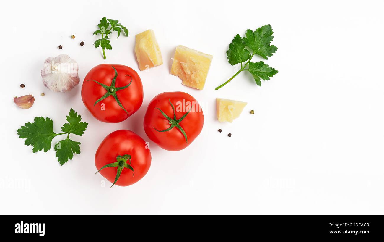Tomatoes, parmesan cheese, parsley and garlic on white background. Copy space, top view. Italian food Stock Photo