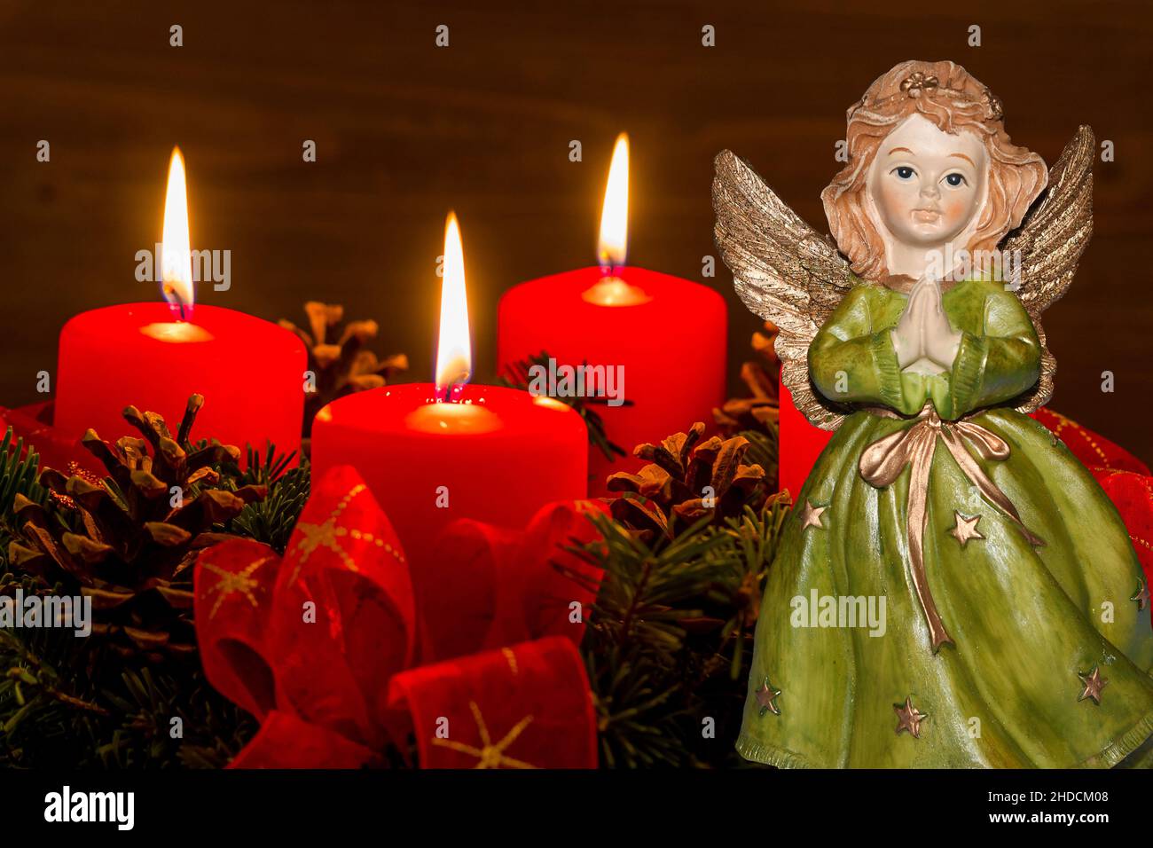 Ein Adventskranz zu Weihnachten sorgt für romatinsche Stimmung in der stillen Advent Zeit. 3 brennende Kerzen, 3. Advent, Engel, Weihnachtsengel, Stock Photo
