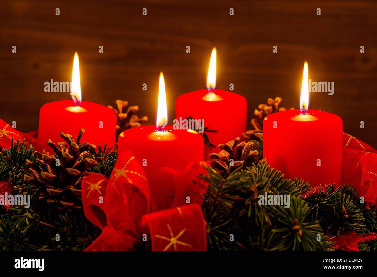 Ein Adventskranz zu Weihnachten sorgt für romatinsche Stimmung in der stillen Advent Zeit. 4 brennende Kerzen, 4. Advent, Stock Photo