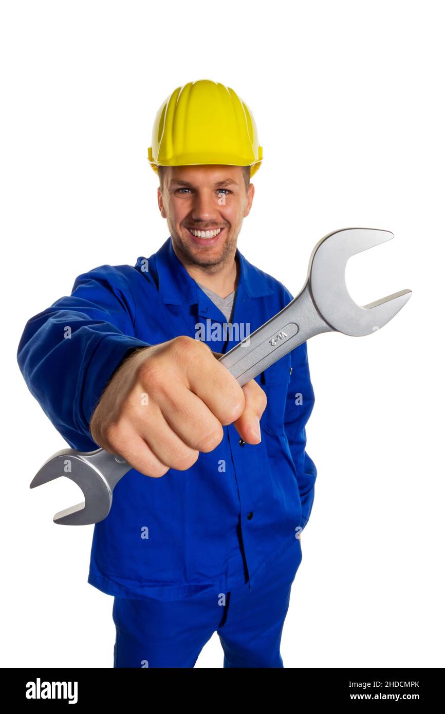 Ein Arbeiter in einem Gewerbebetrieb ( Handwerker ) mit Werkzeug in der Hand, Schraubenschlüssel, 30, 35, Jahre, MR: Yes Stock Photo