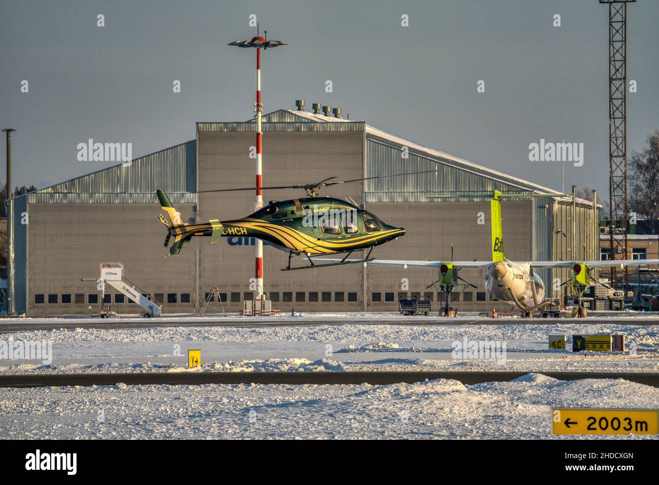 Helicopter parking landing on the roof of a skyscraper with cityscape view at sunset. Stock Photo