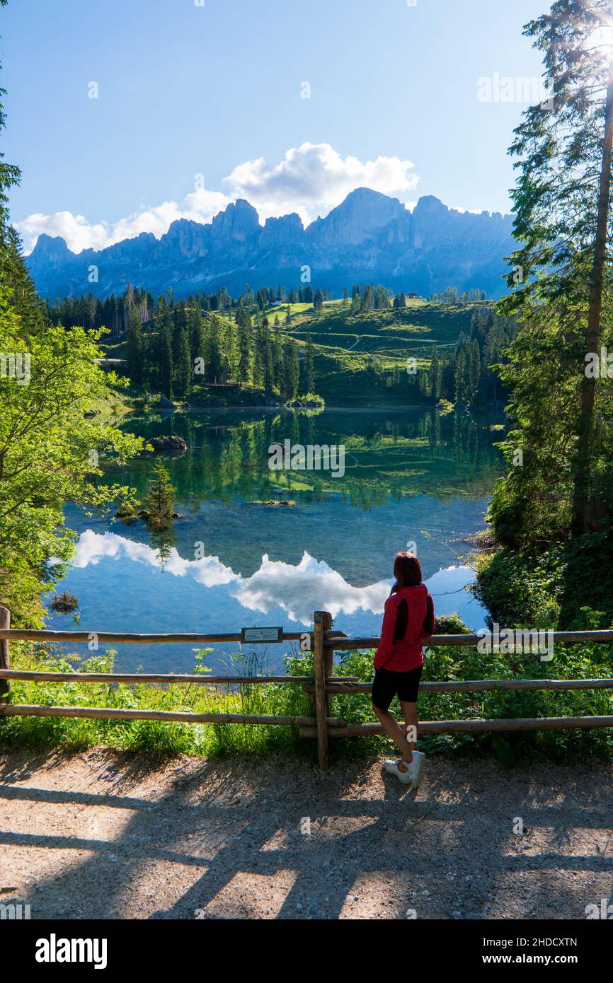 Woman enjoying the turquoise Lago di Sorapiss 1,925m altitude (mountain lake) view as he has mountain walk in Dolomite Mountains, Italy. Active people Stock Photo
