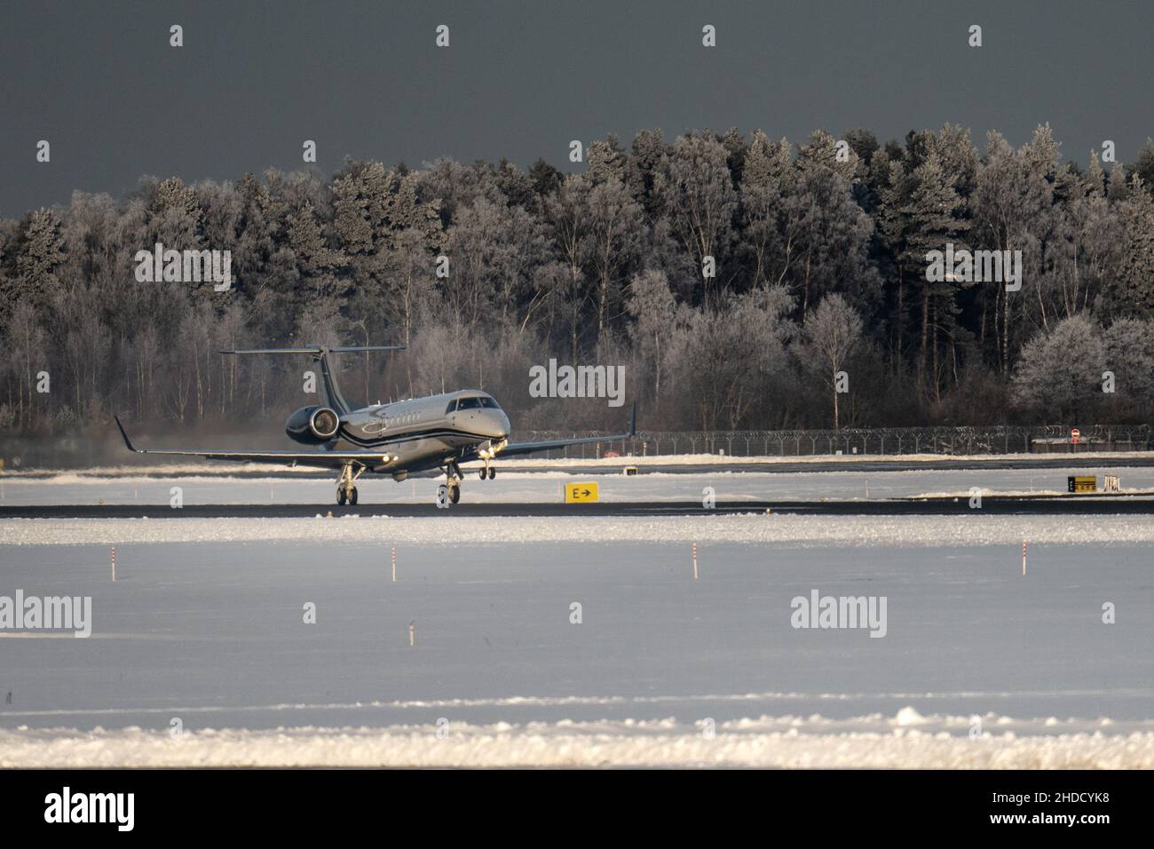 27-12-2021 Riga, Latvia Plane almost landed at the runway. Engine heat behind the plane. Stock Photo