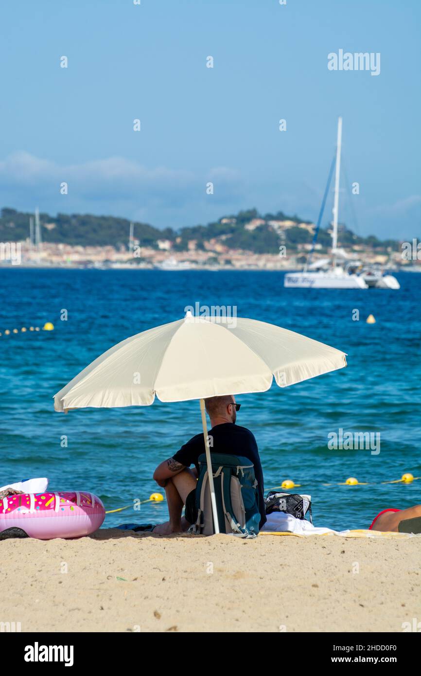 Undentified people sunbathing on sandy beach on French Riviera, Var