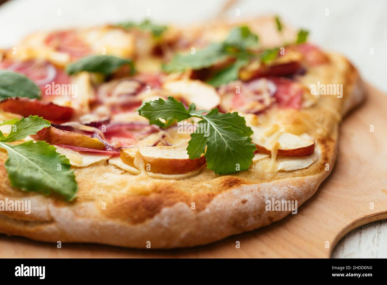 Home made vegan pizza with parsnip, apple and chioggia beet. Stock Photo