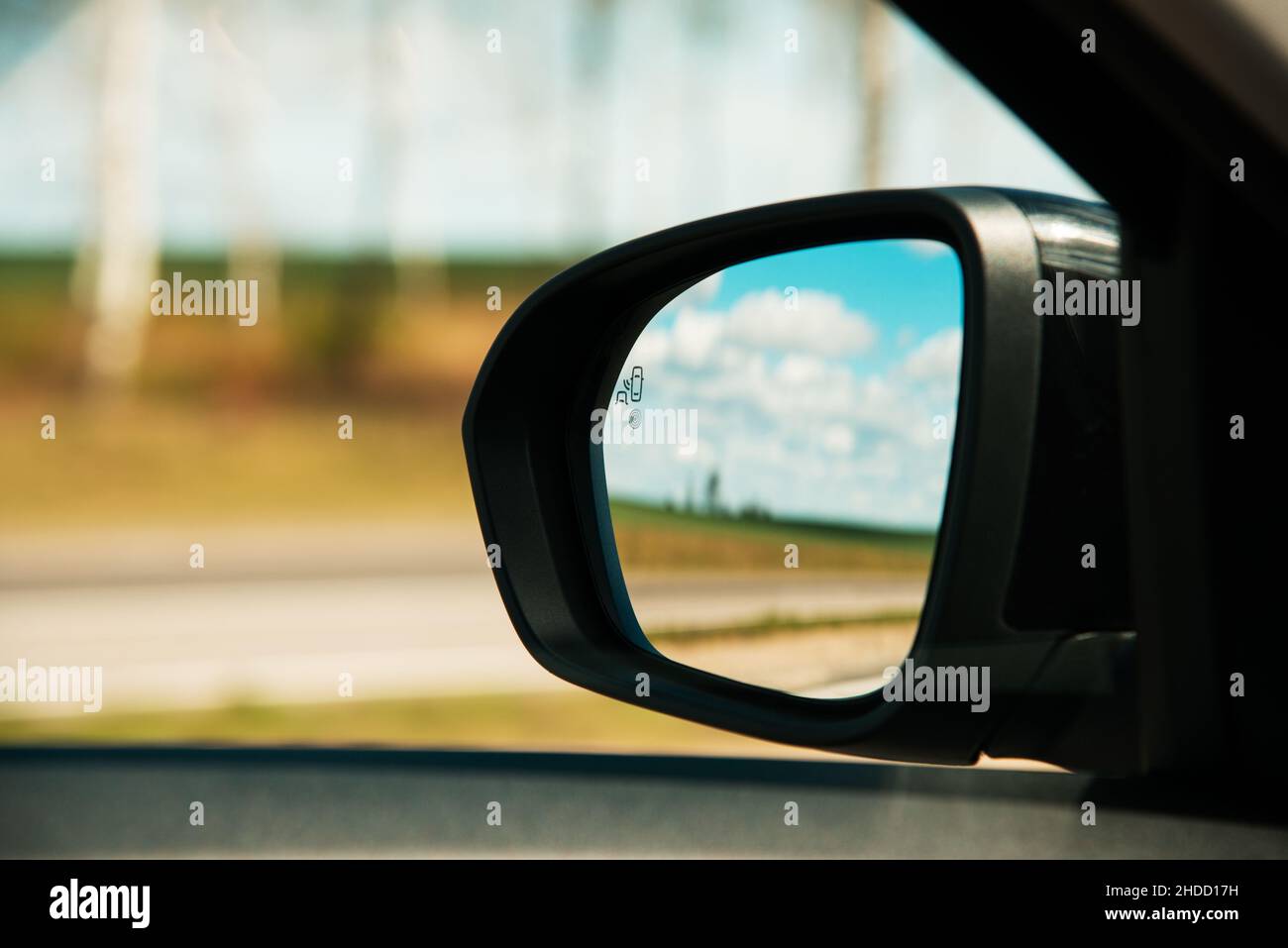 A blind spot monitoring sensor on the side mirror of a modern car Stock