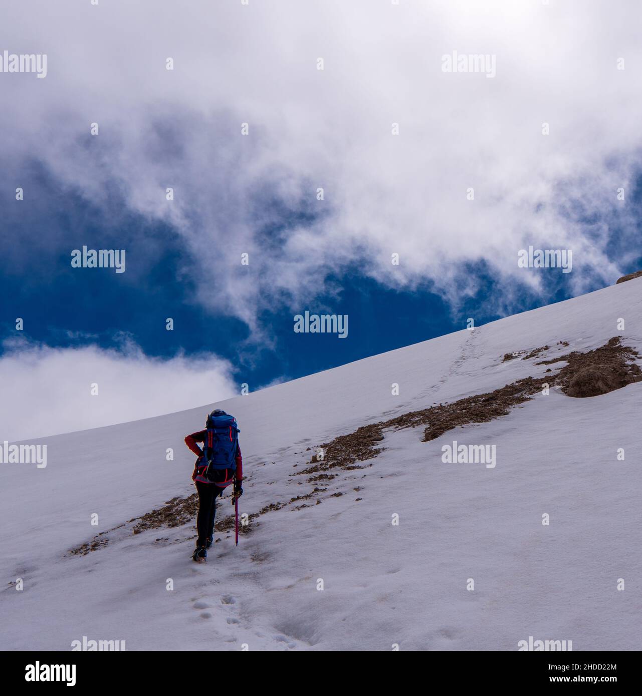 Ascent to Marmolada, Dolomites, Italy. The Marmolada Glacier. Tourist climbing on Marmolada mountain in dolomites. Ice axe in the snow. Ascending Glac Stock Photo
