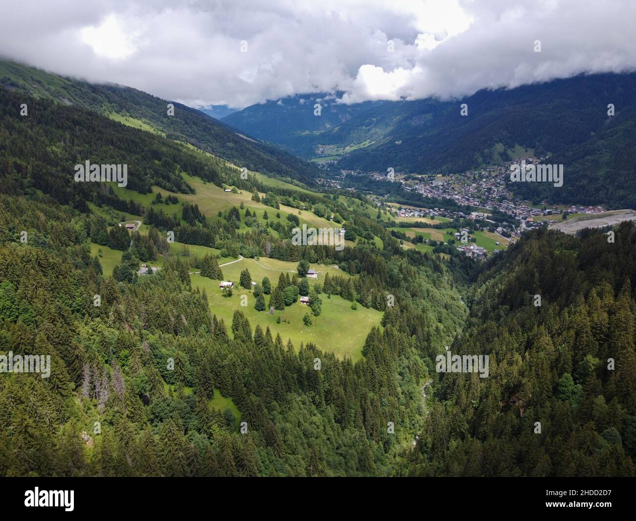 Panoramic view on mountain villages, green forests and apline meadows near Saint-Gervais-les-Bains, Savoy, France in summer Stock Photo