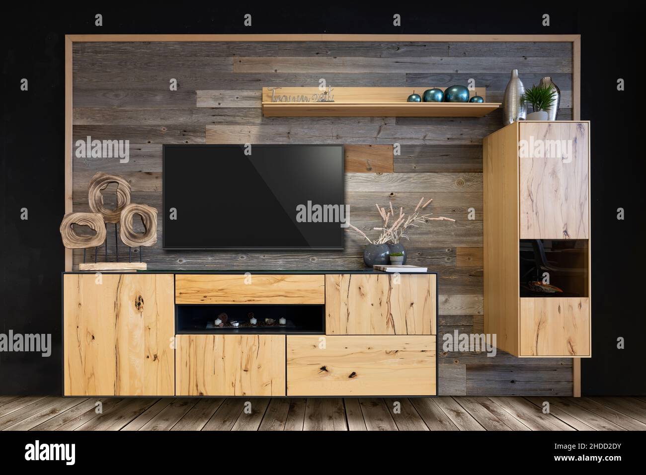 trendy wall unit with television and old wood as a back wall with box shelf and decoration Stock Photo