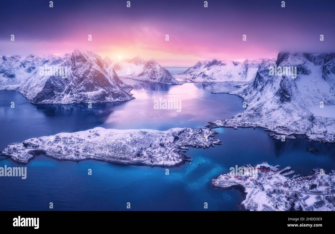 Aerial view of beautiful snowy islands, village, sea, mountains Stock Photo