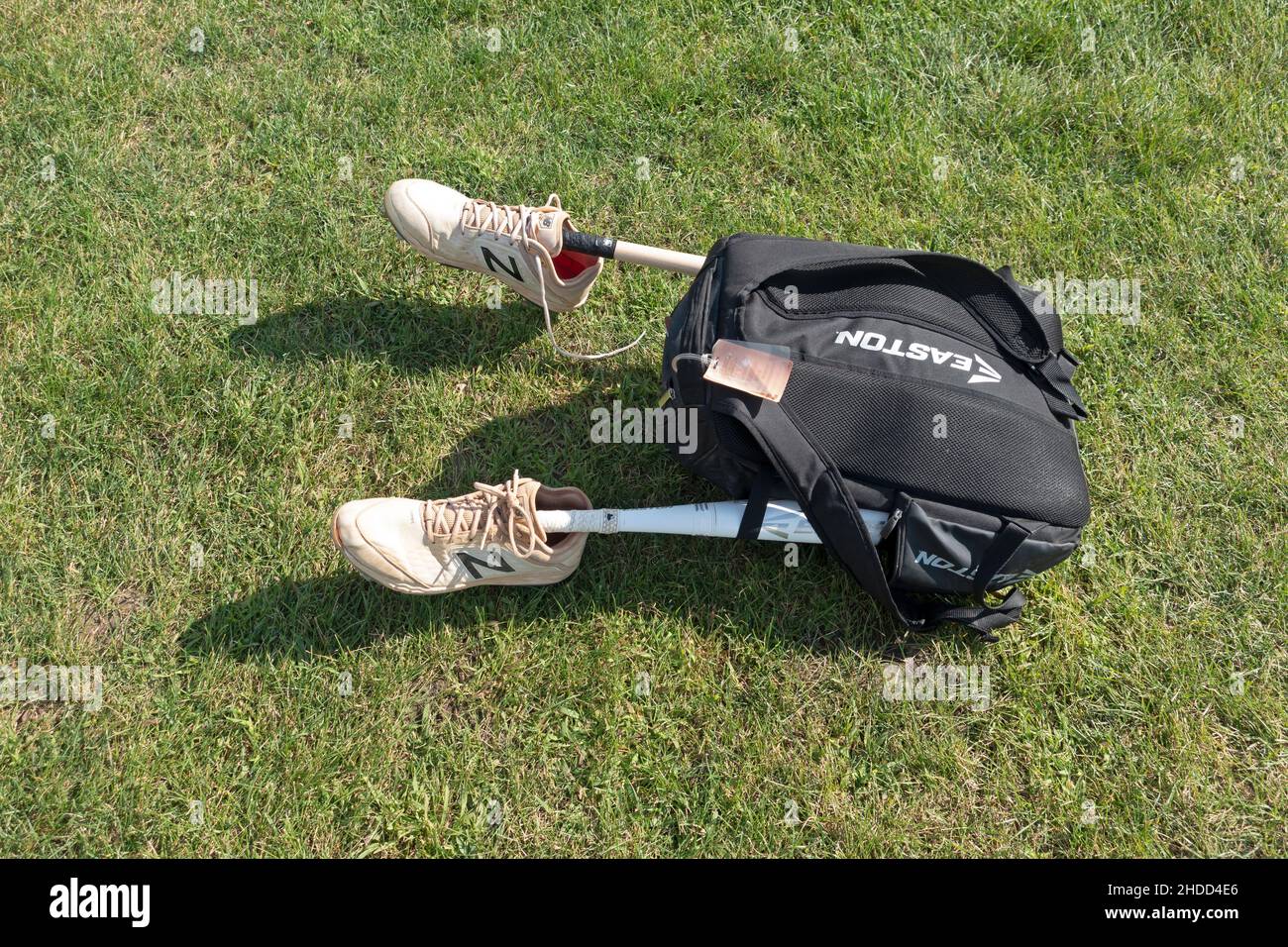 Baseball players backpack with bats attached and shoes on each end looking like half a body with artificial legs. Minneapolis Minnesota MN USA Stock Photo