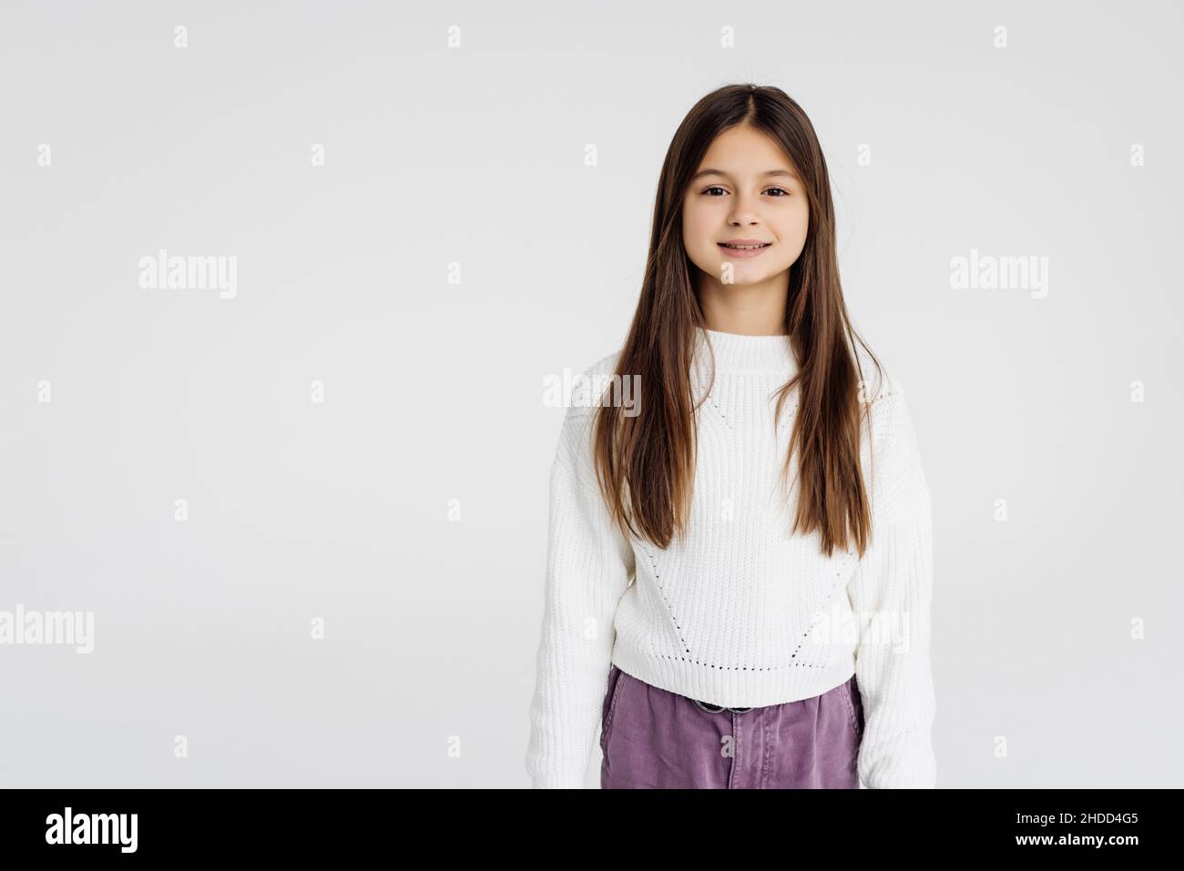 Cute teen girl standing on white background Stock Photo - Alamy