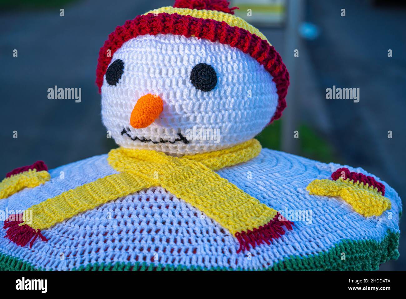 Red, postbox, post box, crocheted, Royal Mail, woolly hats, hand-knitted, pillar boxes, Lincoln City, bobble hat and scarf, The Snow Snowman, Xmas. Stock Photo