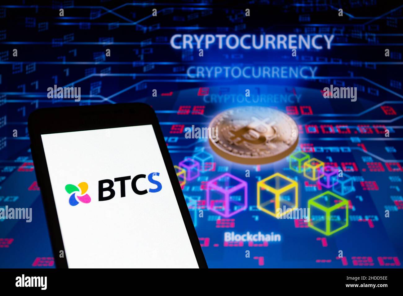 Asuncion, Paraguay. 5th Jan, 2022. Illustration: Logo of BTCS is displayed  on a smartphone backdropped by visual representation of Bitcoin  cryptocurrency, blockchain and numbers. BTCS Inc. (Nasdaq: BTCS), a blockchain  technology-focused company,