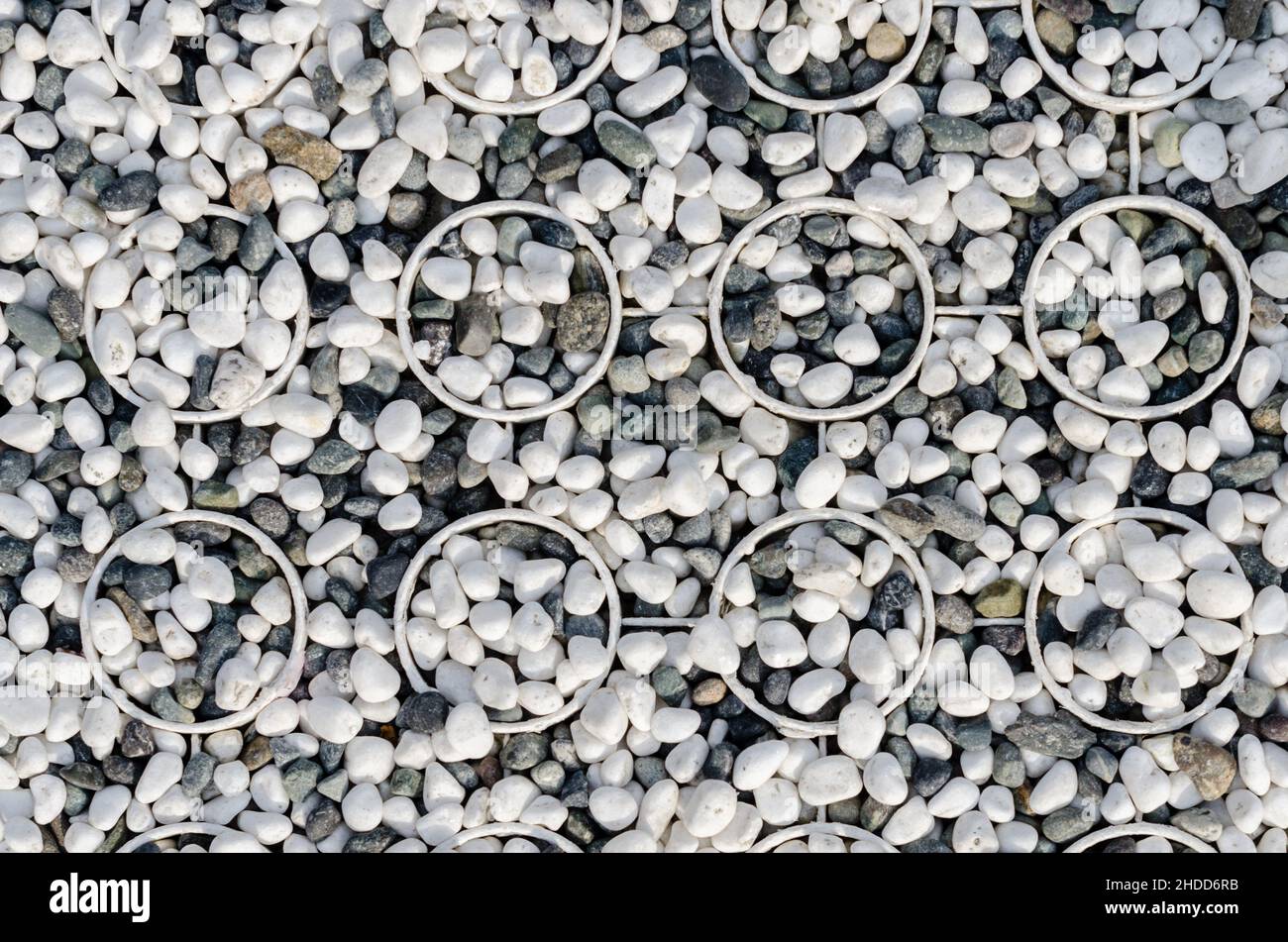 Small black and white stones embedded in cylinders that are part of the floor outside the temple at Izumo Taisha in Japan Stock Photo