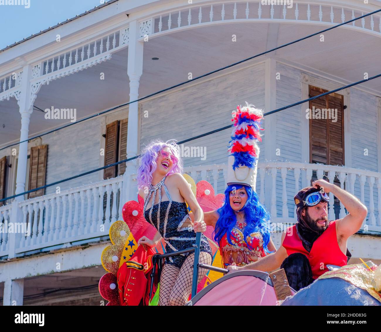 NEW ORLEANS, LA, USA - FEBRUARY 13, 2018: Man and two women riding a float in the St. Anne Parade on Mardi Gras day Stock Photo