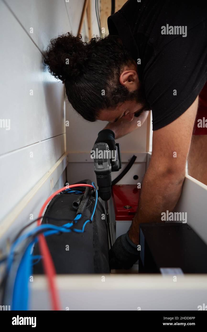 installing second battery inside a camper van Stock Photo Alamy