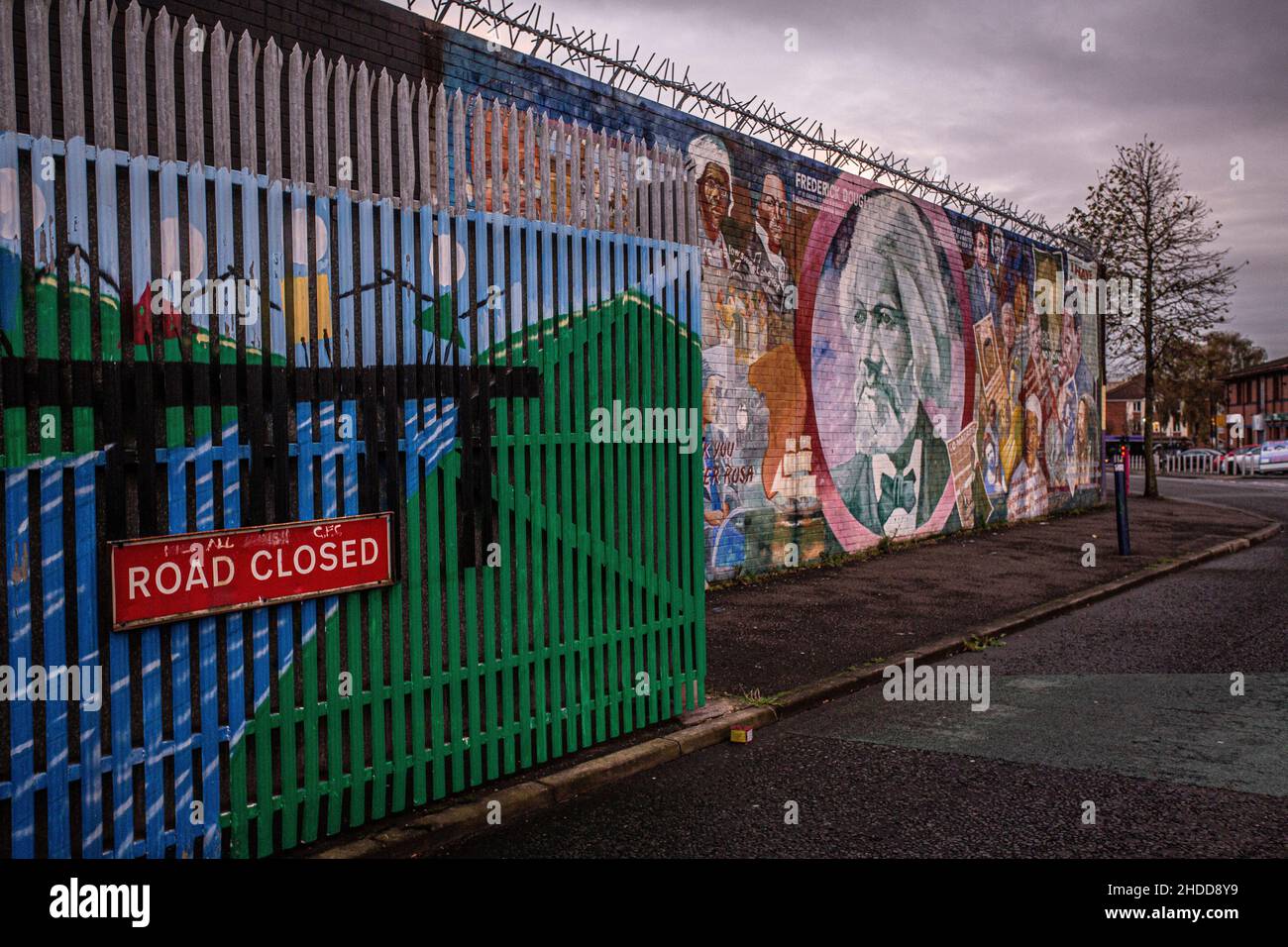 Road closed sign. Security iron gate separating Catholic and Protestant communities, at Belfast peace wall. Northern Ireland, United Kingdom, UK Stock Photo