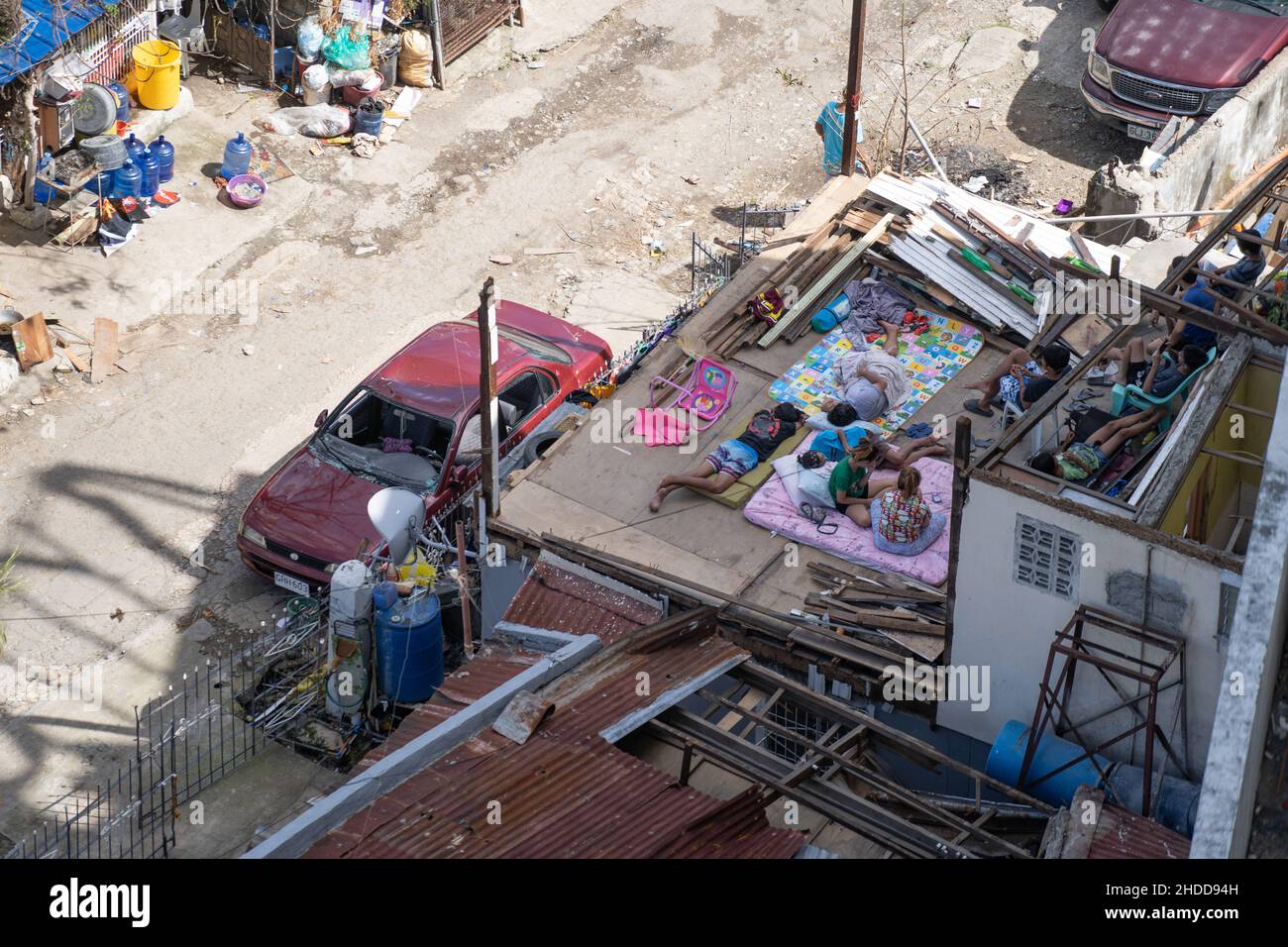 03/01/2022 Cebu City, Philippines. People lying & sitting within their home destroyed by Typhoon Odette (International name Rai). Stock Photo